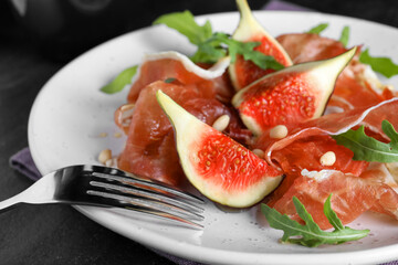 Delicious figs and proscuitto on plate, closeup