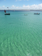 small boats in the crystal clear waters of St. Ives Bay, Cornwall