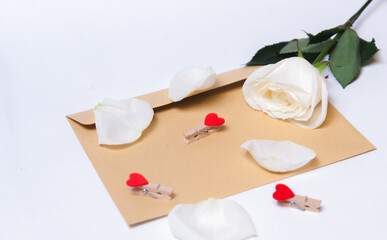 
the rose lies on a paper envelope as a background. valentine's day celebration and eighth march concept