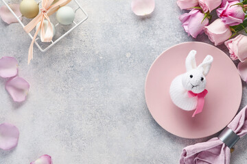 Easter table setting with floral decor on grey table. Elegance dinner. Mock up. Top view.