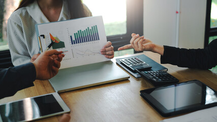 Idea presentation of group business people using a tablet graph chart at the office.