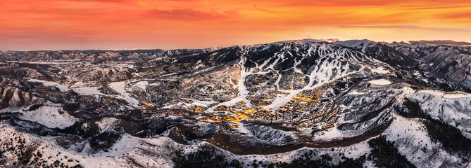 Snowmass Village with sunset and ski slopes 