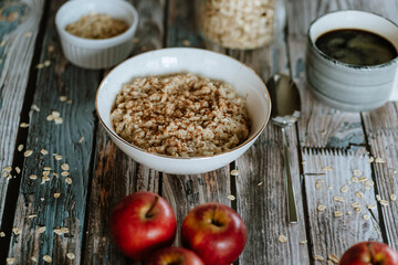 A porridge bowl with apples and cinnamon, food still life, healthy breakfast