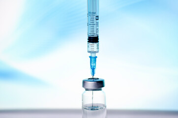 Ampoules and syringe with Covid-19 vaccine on a laboratory table.For the prevention, immunization and treatment of coronavirus infection.Infectious medicine concept. With copy space