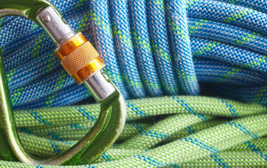 Close up picture of a climbing carabiner and ropes, selective focus.
