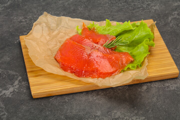 Sliced salmon fillet served rosemary