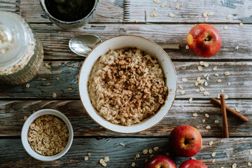 A porridge bowl with apples and cinnamon, food still life, healthy breakfast