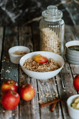 A porridge bowl with apples and cinnamon, food still life, healthy breakfast