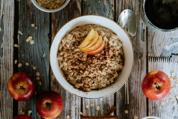 A porridge bowl with apples and cinnamon, food still life, healthy breakfast
