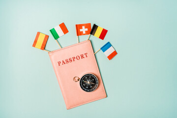 Travel concept passport from which the flags of different European countries stick out. The opportunity to travel to the countries of the Schengen Union.