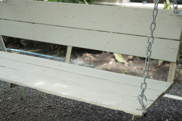 Wooden white swing in garden