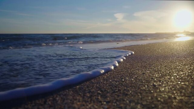 Beach loop of ocean waves during sunset