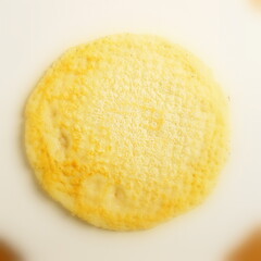 Single pancake made of flour with a sharp center in a frame and blurred cuts made from fresh flour prepared for Shrovetide.
