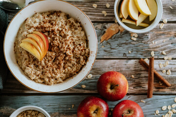 A porridge bowl with apples and cinnamon, food still life, healthy breakfast