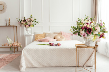 bright lovely bedroom, a bouquet of irises and wild onions on the bed, Beautiful bouquet of...
