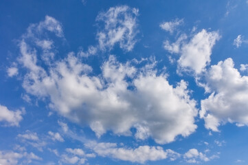 Blue summer sky with white cumulus clouds. Blue sky with clouds nature background.