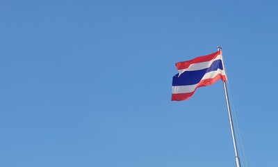 A Thai flag is waving in windy day.
