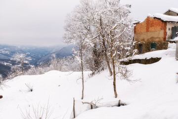 Snowy panorama of the hills surrounding the village of Brallo (Lombardy, Northern Italy, Pavia Province), village in the hilly area of Oltrepo Pavese, along the road pass between Lombardy and Liguria.