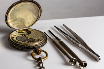 Vintage, pocket Swiss watch and two screwdrivers and tweezers