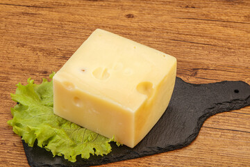 Emmental cheese over wooden board