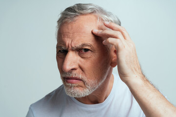 Handsome senior  isolated on grey background. Concept about the third age and seniority