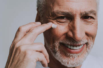 Handsome senior  isolated on grey background. Concept about the third age and seniority