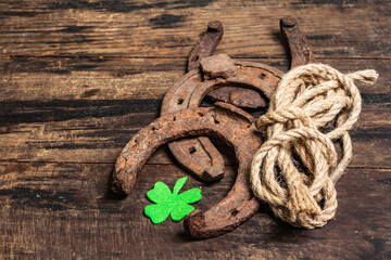 Badly worn horseshoes, rope, and felt clover leaf