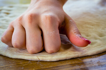 hand of person kneading flour with water and yeast for homemade bread cordoba argentina