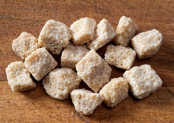 Brown sugar cubes on wooden table