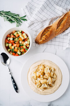 Hummus with cauliflower, tomato and cucumber salad, bread. Middle Eastern dish
