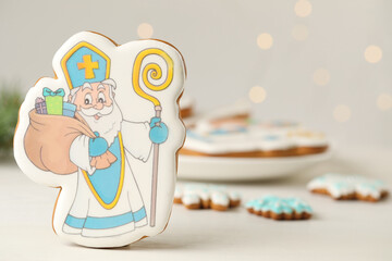 Delicious gingerbread cookies on white wooden table, closeup with space for text. St. Nicholas Day celebration