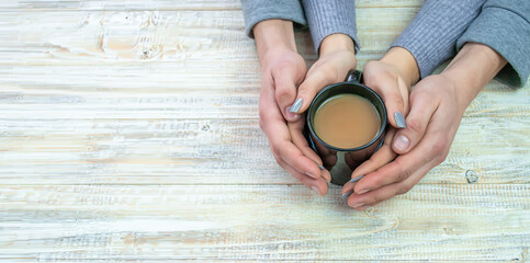 Concept of male and female hands, love and coffee
