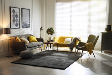 Stylish living room with sofas. Interior design in grey and yellow colors