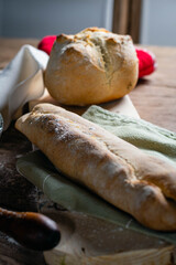 Hot homemade bread with moisture vapor freshly made in a Chilean clay oven with white flour and women's hands Cordoba Argentina
