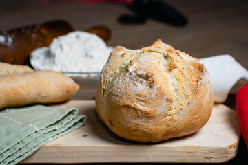 Hot homemade bread with moisture vapor freshly made in a Chilean clay oven with white flour and women's hands Cordoba Argentina