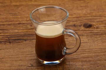 Hot Espresso coffee over wooden table