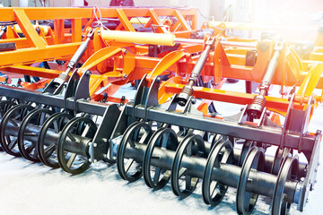 Rollers on universal agricultural cultivator with spring struts