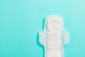 Sanitary pad on blue background with copy space