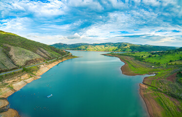 Aerial view at the Lake of Furnas at Capitólio - MG, Brazil. Beautiful landscape between mountains on a blue sky. Eco tourism destination of Minas Gerais state.