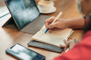 Business woman wear surgical mask to prevent spread Coronavirus (Covid 19) and team work using Laptop Computer with Webinar E-business Browsing Connection and cloud online technology. Selective focus.