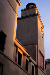 Fototapeta na wymiar Clock tower in Piazza Vittoria, Brescia, Lombardy, Italy, at the sunset