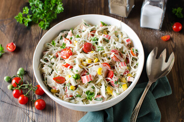 Salad with crab sticks, cabbage and tomatoes