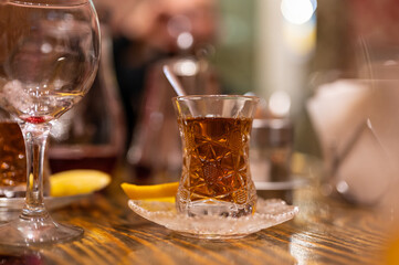 Glass with hot black tea in cafe