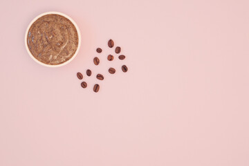 Natural coffee body scrub for cellulite. Coffee beans on a pink background. Body skin care. Flat lay, top view, copy space