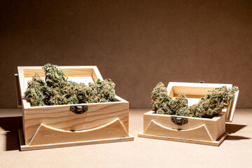 Ready-to-use medical marihuana buds inside two wooden boxes. Selective focus.