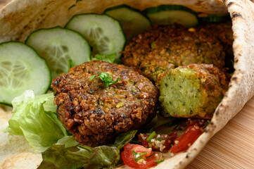 Homemade falafel in pita bread with tomatoes, cucumber and lettuce