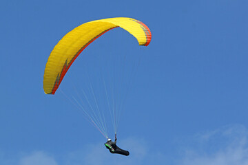 Paraglider flying wing in a blue sky	