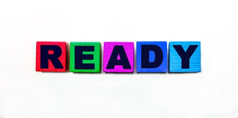 The word READY is written on colorful cubes on a light background