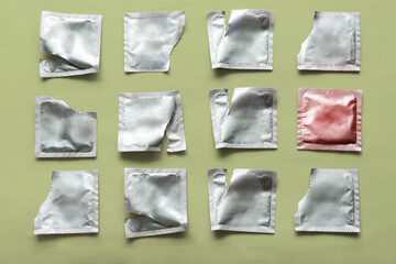 pattern of a condom and many empty packages on a green background