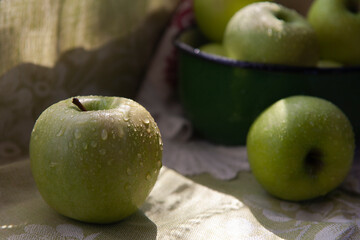 Fresh green apples in a green vintage bowl